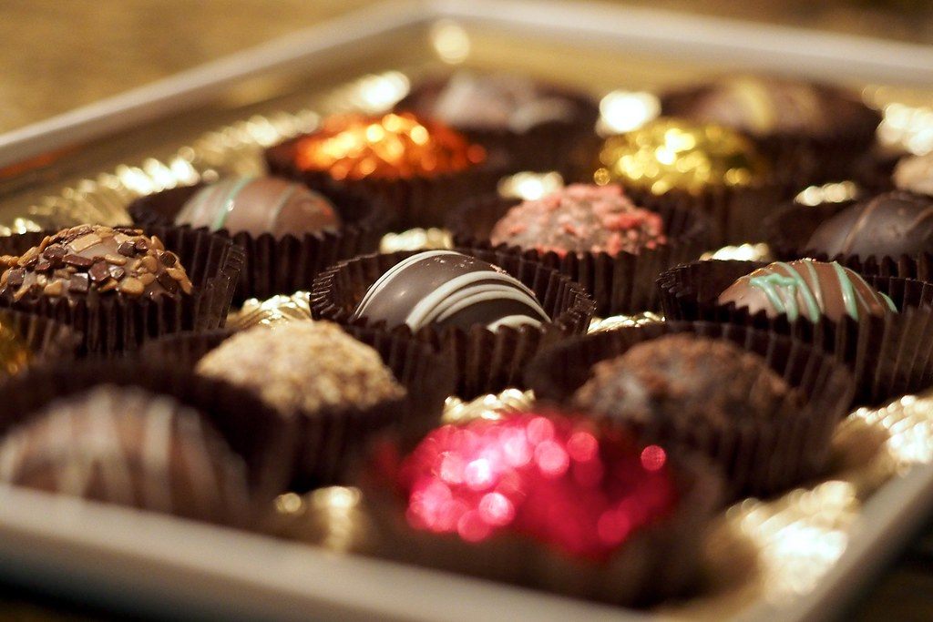 A tray of chocolate coated truffle balls