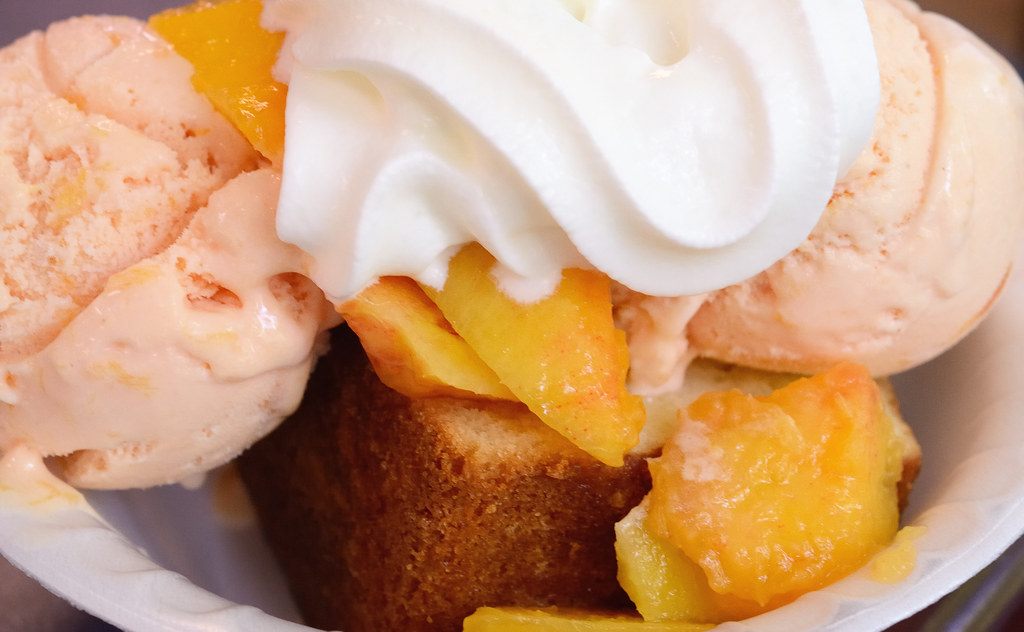 A photo of peaches and cream dessert
