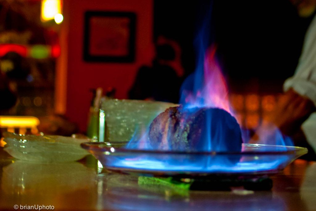 A plum pudding alight on a plate