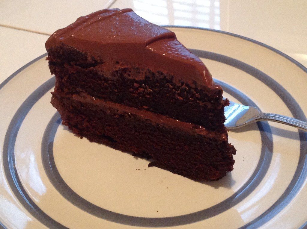A slice of layered chocolate cake on a plate